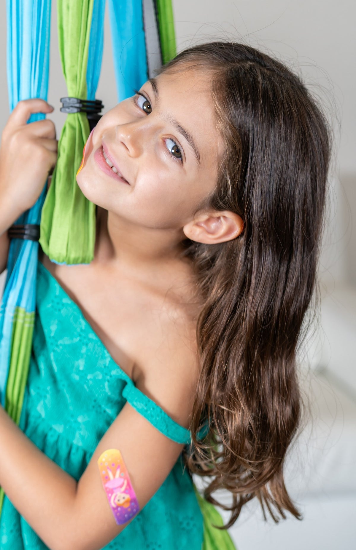 Girl with a BooBoo Cooler bandage on her upper arm