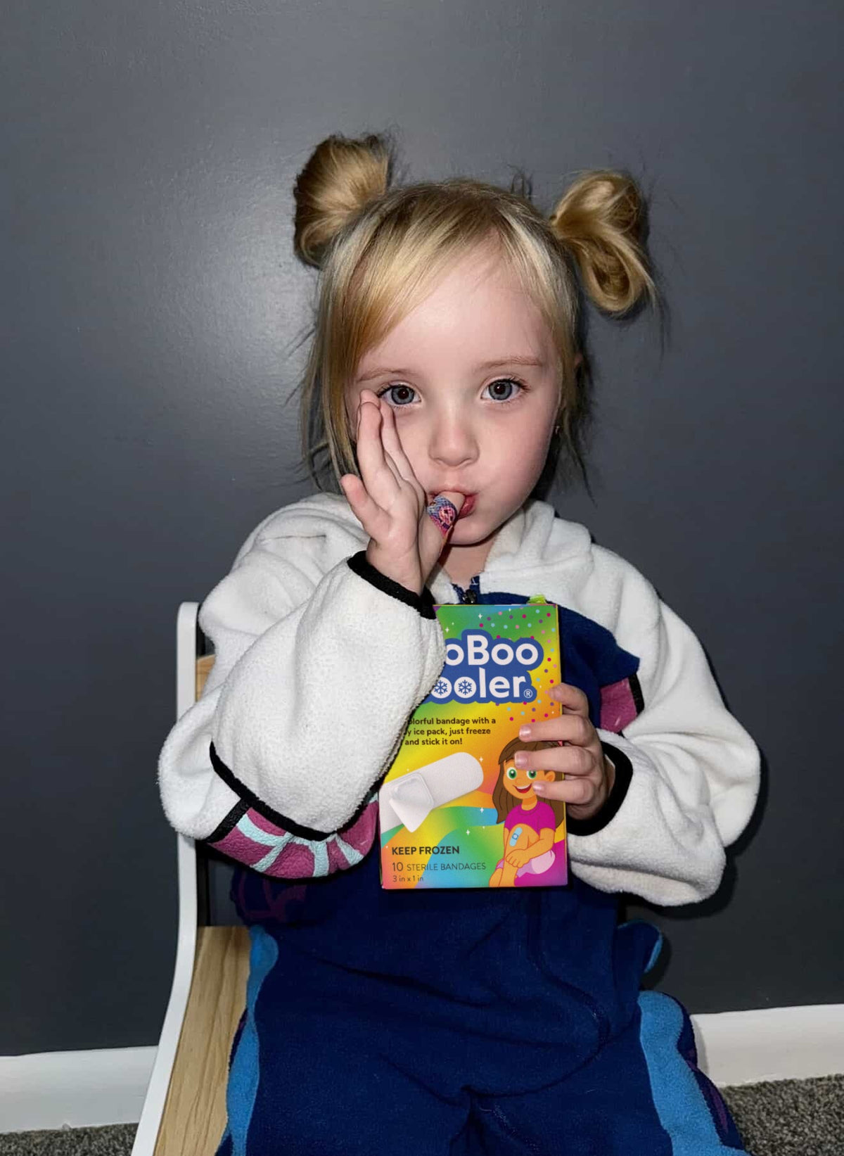 Girl holding a BooBoo Cooler Rainbow Magic box