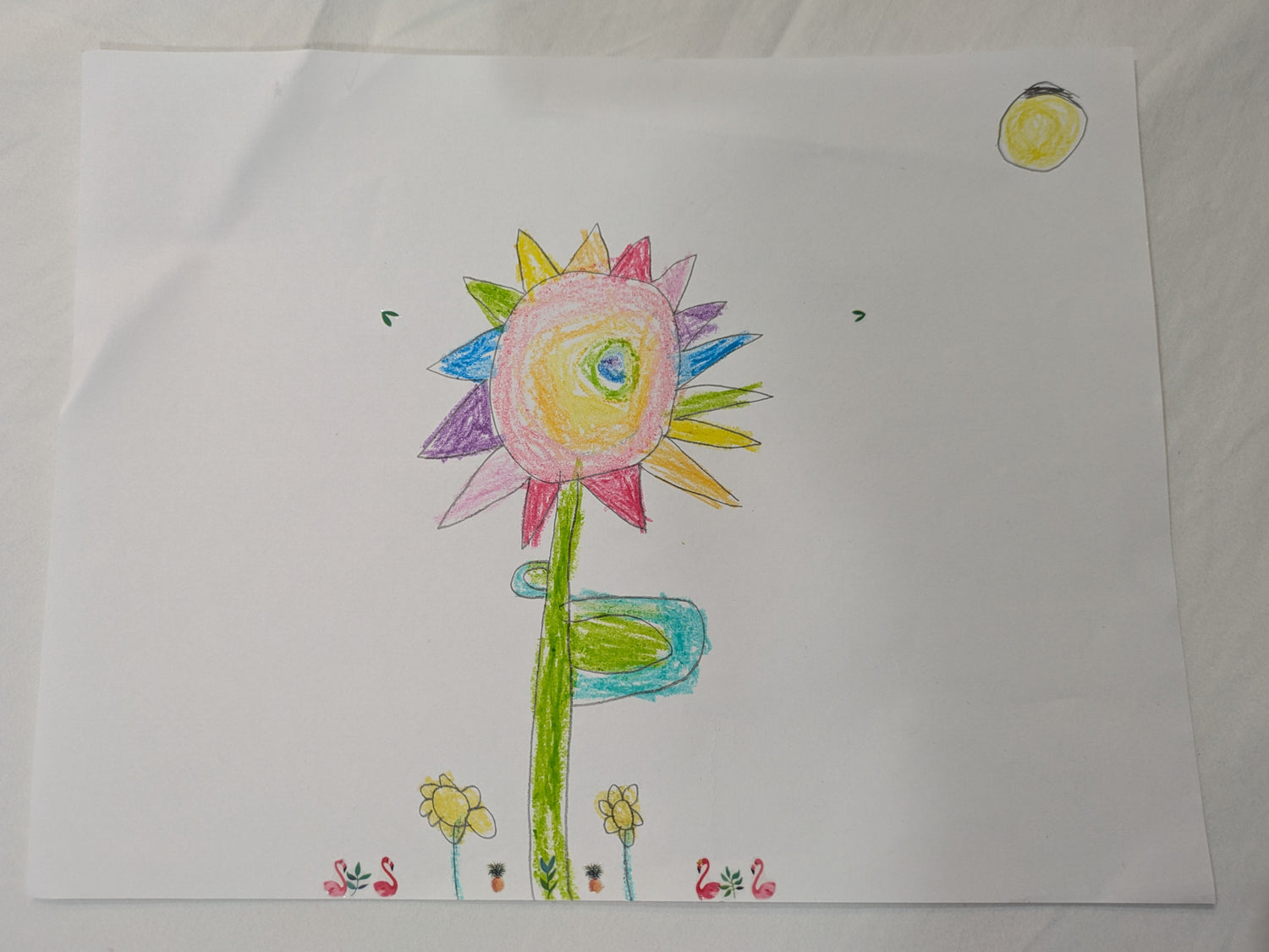Colorful drawing of a flower on a white sheet of paper