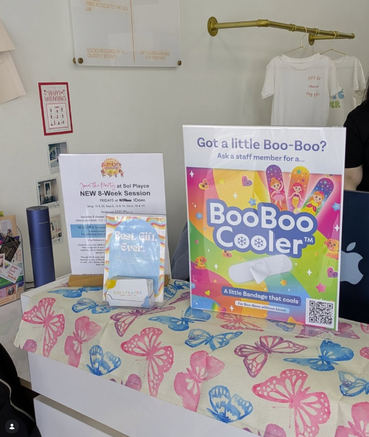 BooBoo Cooler product display with colorful packaging on a table with butterfly pattern at Sol Playce